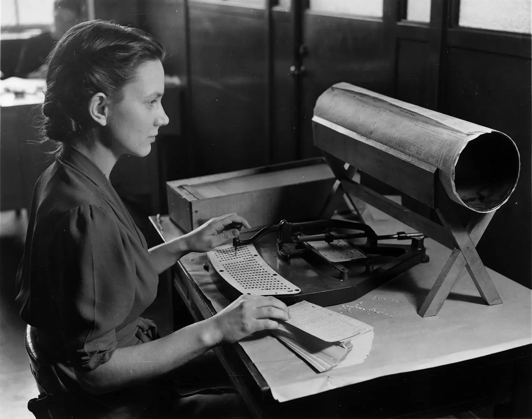 A clerk operating a card puncher used in the United States census tabulation system